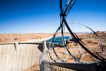 Glen Canyon Dam and Lake Powell with protective and deterrent barbed wire fence around the property