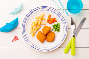 Kid's meal (dinner) - fish, chips, carrot and green peas