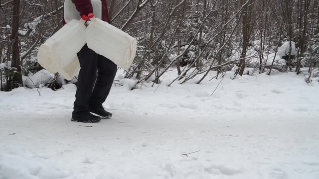 The guy goes to the water at the artesian source. Great day for a walk. He took with him a lot of cans of water.