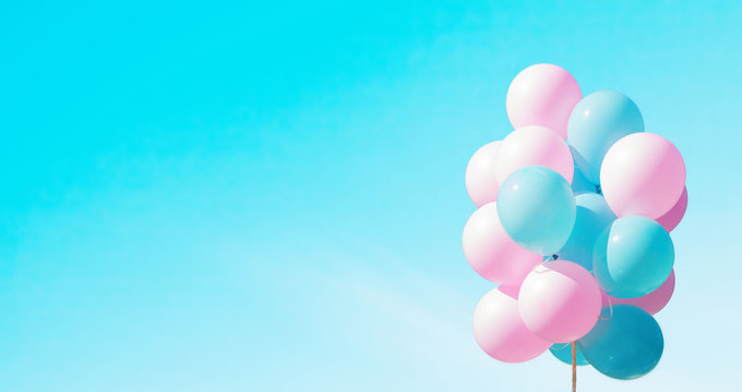 Panoramic background with pink and blue balloons in sky