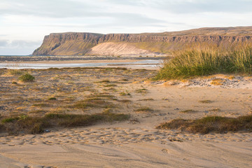 On beach of Breidavik, sunset, westfjords of iceland