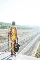 African businessman next to the railroad with the clothes of typical