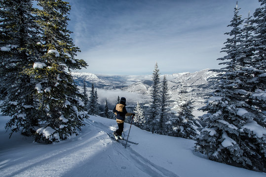 Skier enjoys the view towards the Rocky Mountains during winter