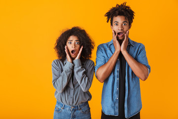 Shocked young african couple standing