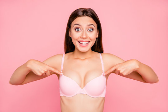 Close up portrait of attractive beautiful delighted gorgeous skinny her she girl showing nice proportions of decollete cleavage in push up bra isolated on pink background