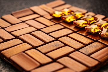 Beautiful and fashionable jewelry and accessories for women. Yellow, orange stones with square stones on dark and wood textured background. Mustard bright rhinestones on a Gold metal base. Interesting