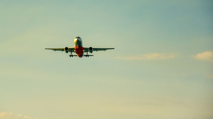 The plane take off against the yellow sky and removes the chassis . copy space for text