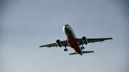 A passenger plane flies in the sky close up. Clear sky safe to fly. Aircraft released landing gear