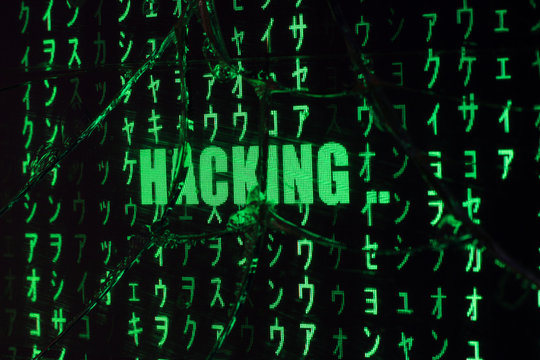 Hacking in progress. Hacking code on a broken computer screen. Green raining codes.