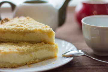 homemade cake with cottage cheese and tea on wooden background,