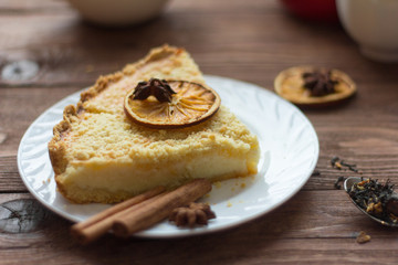 homemade cake with cottage cheese on a wooden background with elements of decor in a rustic style