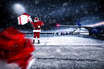 Red old Santa Claus on airport and dark magic night with moon 