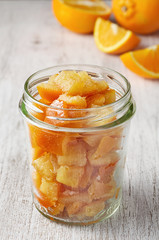 Pieces of candied orange peel coated in sugar in jar