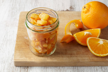 Pieces of candied orange peel coated in sugar in jar