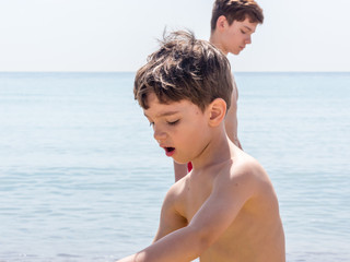 Young boy playing on a beach in French Riviera