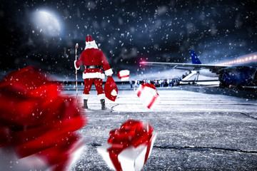 Red old Santa Claus on airport and dark magic night with moon 