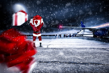 Red old Santa Claus on airport and dark magic night with moon 
