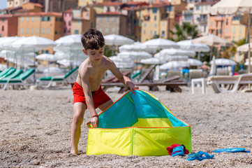 Young boy playing on a beach in French Riviera