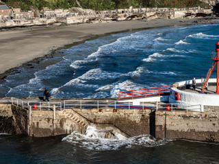 Banjo Pier at Looe in Cornwall with sea rolling by.