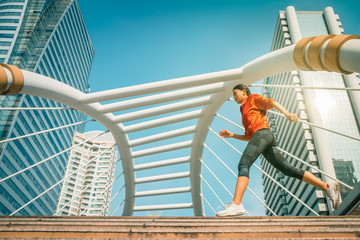 Asian athletic woman having jogging in city for exercise