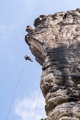 Climber on the rock rope protection.