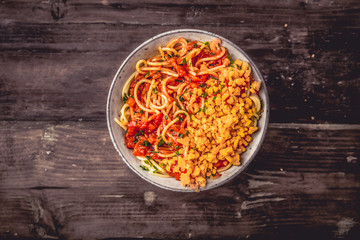 Italian Spaghetti in a bowl with cheddar cheese
