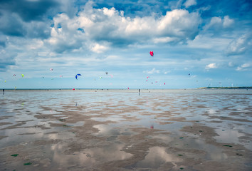 Obraz premium people kite surfing on the beach