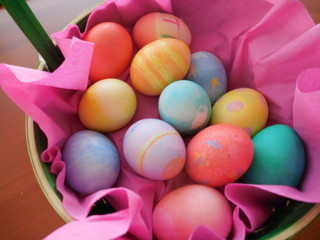 Fototapeta na wymiar Colored Easter eggs in pink basket from above