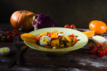 Healthy food. Vegetable salad. Vegetarian salad with vegetables and fruits. Tangerines in the salad.