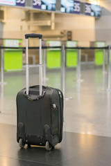 lonely suitcase at the airport. lonely suitcase at the airport. Forgotten baggage at an empty airport. vertical photo