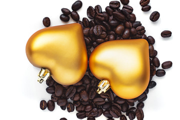 pair of heart shaped decoration on coffee beans