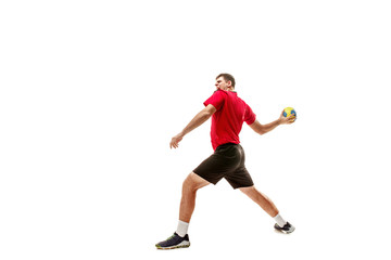 Fototapeta premium The fit caucasian young male handball player at studio on white background. Fit athlete isolated on white. The man in action, motion, movement. attack and defense concept