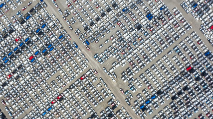 Cars export terminal in export and import business and logistics. Shipping cargo to harbor. Water transport International. Aerial view and top view.