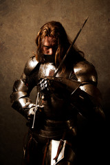 Portrait of a knight in armor in attack position