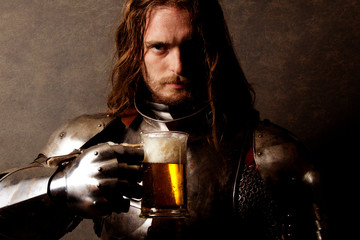 Portrait of a knight in armor drinking a beer