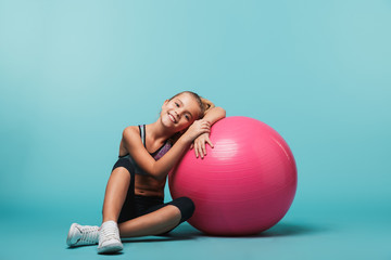 Cheerful little girl wearing sport clothes