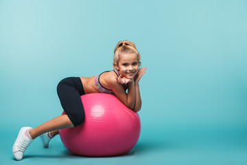 Cheerful little girl wearing sport clothes