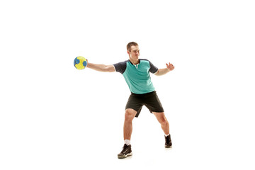 Naklejka na ściany i meble The fit caucasian young male handball player at studio on white background. Fit athlete isolated on white. The man in action, motion, movement. attack and defense concept