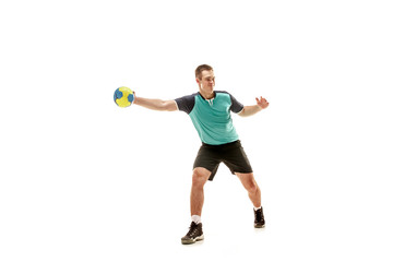 The fit caucasian young male handball player at studio on white background. Fit athlete isolated on white. The man in action, motion, movement. attack and defense concept