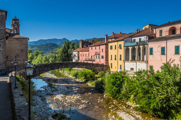 Fototapeta na wymiar Tuscan town of Pontremoli with a view of the colorful homes on the banks of the river Magra. Pontremoli is a town in the region of Tuscany, Italy. 