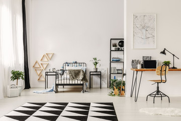 Black and white interior design of spacious kid's bedroom with workspace
