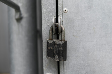 Padlock on the metal door. Silver Lock.