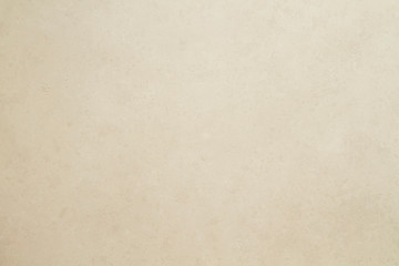 Beige colored tiled wall texture or background