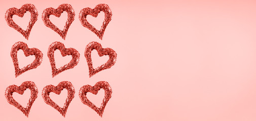Glitter hearts on pink background.  Valentines day and love concept . Living coral theme - color of the year 2019