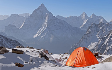 Tent camp at sunrise on the background of Ama Dablam peak (6814 m) in Nepal, Himalayas.