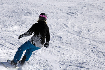 Fototapeta na wymiar Snowboarder riding the slope