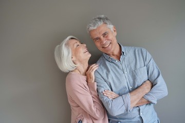  Lovely portrait of attractive senior couple on grey background