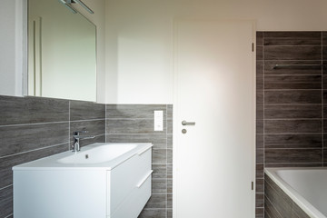 Bathroom with elegant minimalist brown tiles