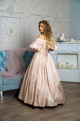 Girl in beautiful vintage dress posing in the studio