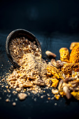 Close up of Dried dates or kharek or sukhi khajoor in a hamper with its powder on wooden surface.
